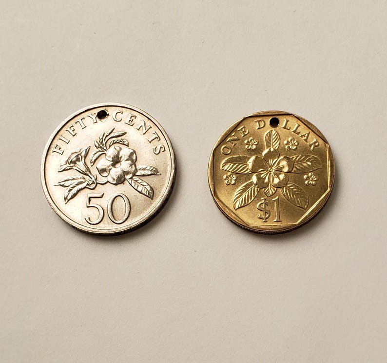 May include: Two Singaporean coins, one gold and one silver. The gold coin is a one dollar coin with a flower design and the text "ONE DOLLAR". The silver coin is a fifty cents coin with a flower design and the text "FIFTY CENTS".