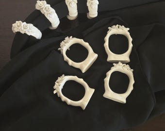 Set of Eight Vintage Porcelain Napkin Rings with Floral Motifs.