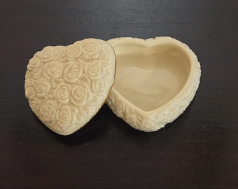 Lenox ivory porcelain heart-shaped trinket box with sculpted roses and gold trim.