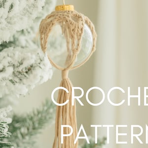 May include: A crocheted ornament with a tassel hanging from a snowy Christmas tree. The ornament is made of beige yarn and is wrapped around a clear glass ball. The text "CROCHET PATTERN" is visible in the image.