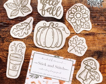 May include: A set of nine water-soluble embroidery designs featuring fall-themed illustrations. The designs include a pumpkin, leaves, a coffee cup, mushrooms, and the text "hello fall".