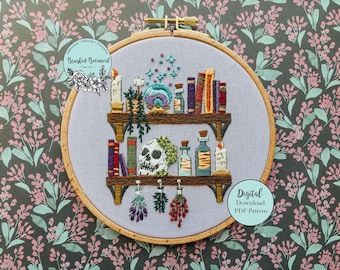 May include: Embroidered hoop art featuring a witchy bookshelf design. The artwork includes shelves with books, potion bottles, candles, and a skull. The text "Brushed Botanical" and "Digital Download PDF Pattern" are also visible.