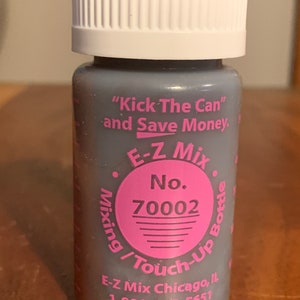May include: A gray E-Z Mix touch-up bottle with a white cap. The bottle has pink text that reads "Kick The Can and Save Money" and "E-Z Mix No. 70002". The bottle is for mixing and touch-up.