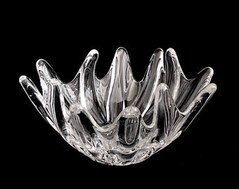 May include: A clear glass bowl with a unique, wavy design. The bowl is shaped like a flower with multiple points.