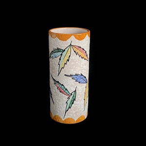 May include: A white ceramic vase with a textured surface and a yellow rim. The vase is decorated with colorful leaf designs.