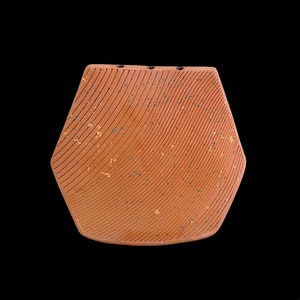 May include: A terracotta-colored ceramic vase with a geometric shape and a textured surface. The vase has a speckled finish with gold flecks.