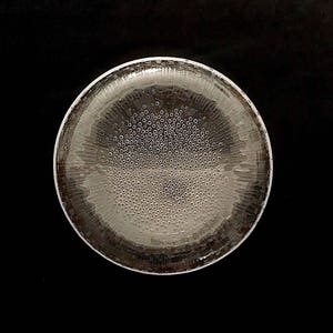 May include: A clear glass bowl with a textured surface and a pattern of small bubbles.