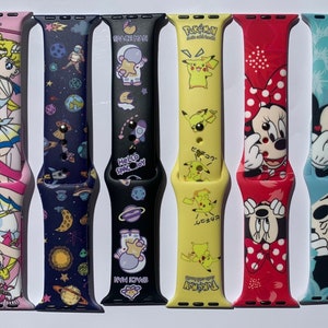 May include: Eight different colorful silicone watch bands with various cartoon characters and designs. The bands are for Apple Watches and feature characters like Mickey Mouse, Pikachu, and Sailor Moon.