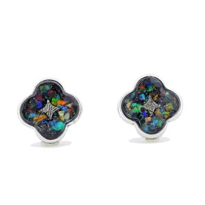 May include: A pair of silver earrings with a four-leaf clover design. Each clover has a black background with a silver star and iridescent opal-like stones.