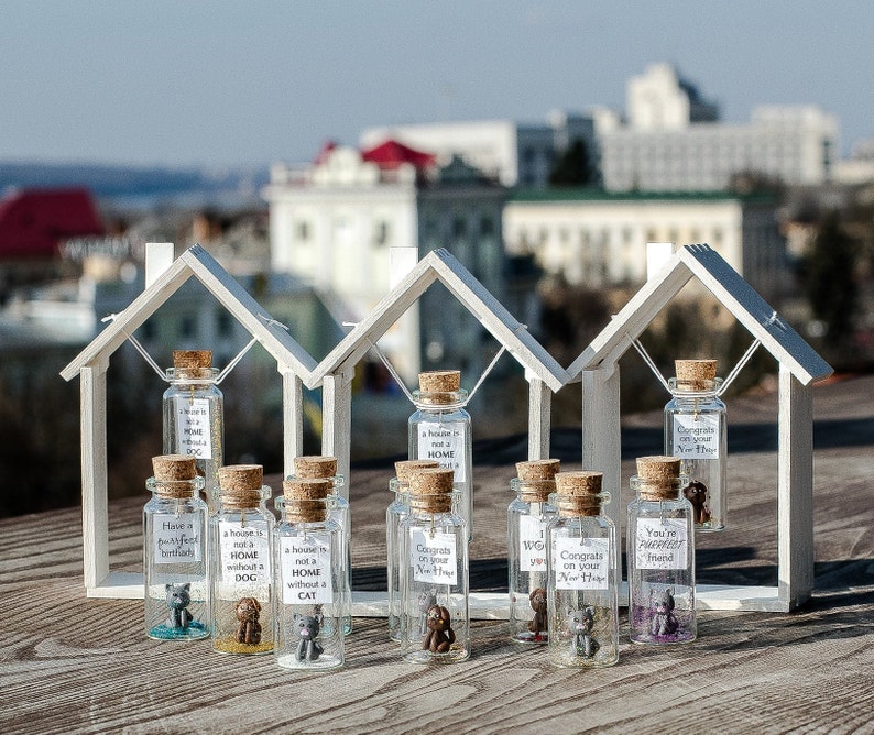 a group of small glass bottles with tiny houses in them