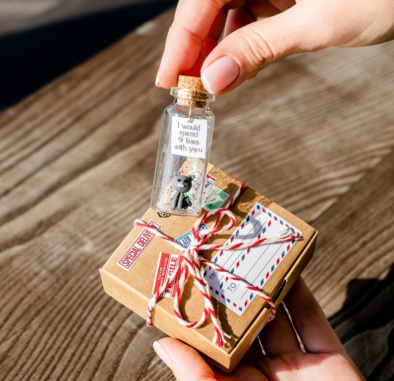 a person holding a bottle with a message inside of it