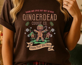 Puede incluir: Camiseta marrón con un diseño de hombre de jengibre y el texto "GINGERDEAD COOKIE CO." El diseño incluye las frases "Sugar and Spice But Not So Nice" y "Treats That Bite Back".