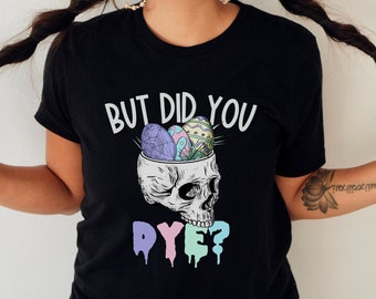 May include: Black t-shirt with a skull graphic and the text "But did you dye?"  The skull is filled with colorful Easter eggs.