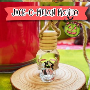 May include: A clear glass skull-shaped bottle with a wooden top and a rope hanger. The bottle is filled with a green liquid. The text "JACK-O-MELON MOJITO" is displayed on a red banner above the bottle. The bottle sits on a wooden slice.