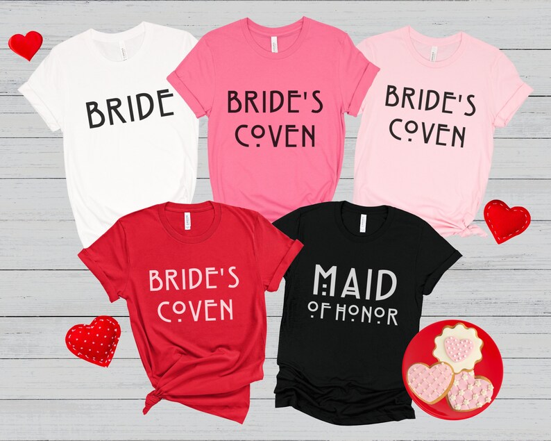 May include: Five t-shirts with different text printed on them. The shirts are white, pink, red, and black. The text on the shirts reads "Bride", "Bride's Coven", "Maid of Honor", and "Bride's Coven".