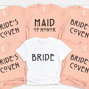 May include: Five peach-colored t-shirts with black text that reads "Bride's Coven" and one white t-shirt with black text that reads "Bride" and "Maid of Honor".