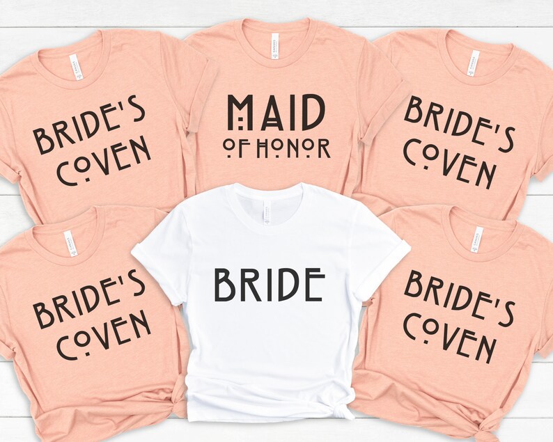May include: Five peach-colored t-shirts with black text that reads "Bride's Coven" and one white t-shirt with black text that reads "Bride" and "Maid of Honor".