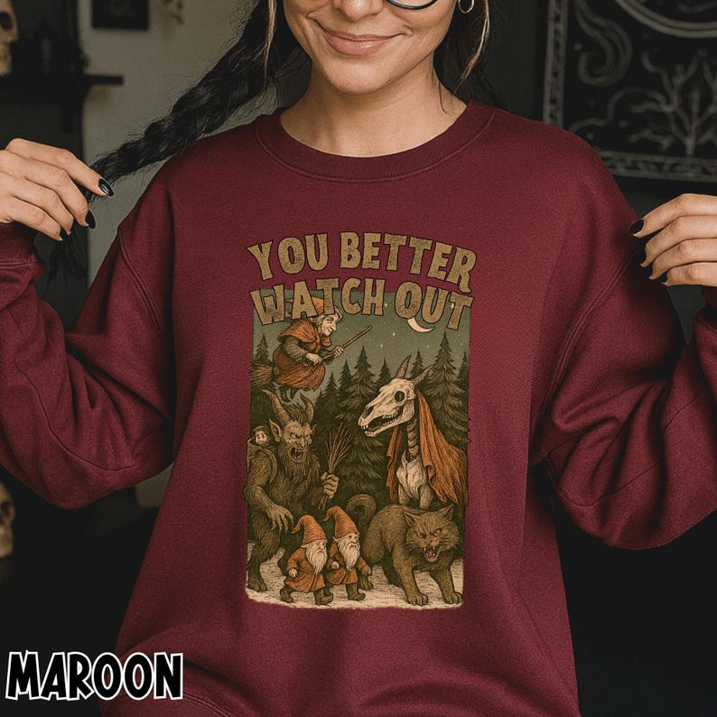 May include: Maroon sweatshirt with the text "YOU BETTER WATCH OUT" above a graphic of fantasy creatures in a forest scene. The graphic includes a witch, gnomes, a skeletal horse, a cat, and a goblin. The word "MAROON" is printed at the bottom.