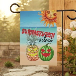 May include: A garden flag with a summer and Halloween theme. It features a smiling sun, a pineapple with a jack-o-lantern face, a watermelon with a jack-o-lantern face, and the text "Summerween vibes".