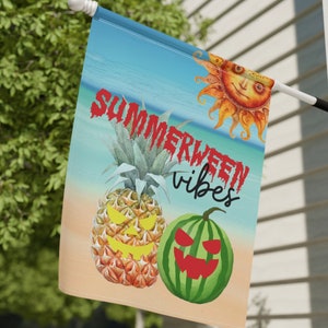 May include: A summer-themed garden flag with a beach scene, a pineapple, a watermelon, and a sun with a smiling face. The text on the flag reads "Summerween vibes".