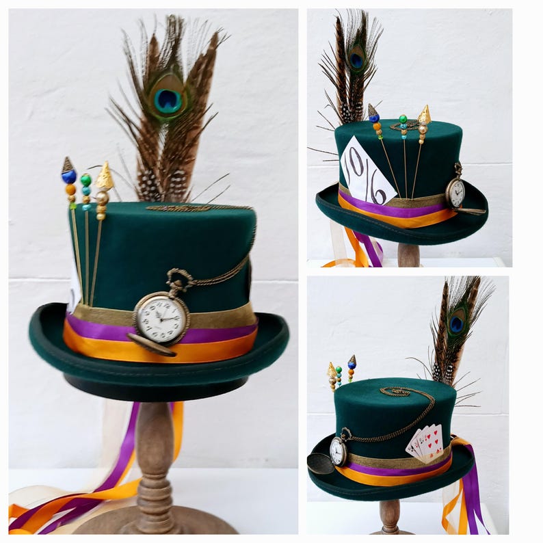 May include: A green top hat with a purple and orange ribbon, a pocket watch, and a peacock feather. The hat has a 10/6 tag on the side.