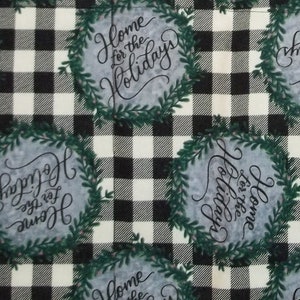 May include: Black and white buffalo plaid fabric with a repeating pattern of wreaths with the text "Home for the Holidays" in black script.