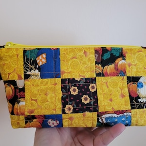 Handmade quilted zipper pouch, vintage fabric, with pumpkins, flowers, swirls of yellow, 5&quot; tall, 8&quot; wide, 2&quot; deep