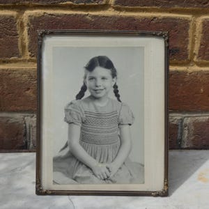Vintage Framed Black and White Portrait Photograph of a Young Girl in Pigtails