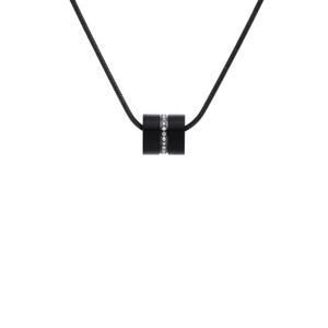 May include: A black necklace featuring a cylindrical pendant. The pendant has a band of small, sparkling crystals encircling its center. The necklace chain is also black, creating a sleek, minimalist design.