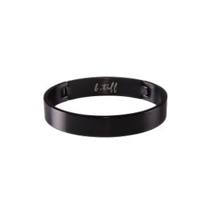 May include: A black metal bangle bracelet with the inscription "b.till" on the inside.