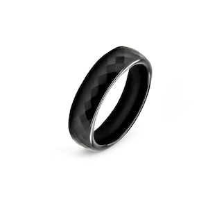May include: A black ring with a diamond-shaped pattern on the surface.