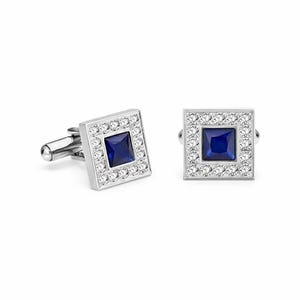 May include: A pair of silver cufflinks with a square design. Each cufflink features a dark blue square center stone surrounded by a border of small, clear stones. The cufflinks are set against a white background.