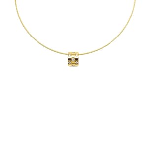 May include: A gold-colored necklace with a small, square pendant. The pendant is a cube shape with alternating squares of clear stones and brown-toned squares. The necklace chain is a thin, gold-colored wire.