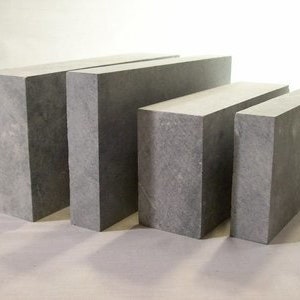 May include: Four rectangular blocks of gray concrete, arranged in descending size from left to right.