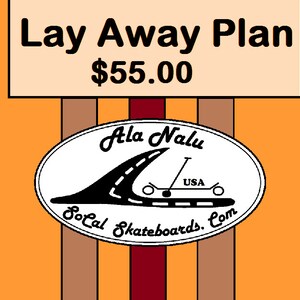 May include: A sign with the text "Lay Away Plan $55.00" above a white oval with the text "Ala Nalu SoCal Skateboards.com" and a black and white illustration of a skateboard with a wave and the text "USA".