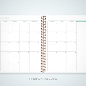May include: A two-page monthly calendar spread for June 2023. The calendar is divided into seven columns for each day of the week, with a separate column for notes. The calendar is designed with a simple, clean layout and features a gold spiral binding.