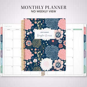 May include: A monthly planner with a floral design in shades of pink, blue, and white. The cover features a gold spiral binding and the text "2025 Planner - Kayla Cross".