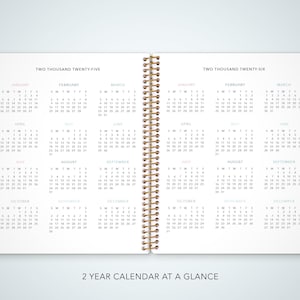May include: A two-year calendar at a glance, with monthly pages for 2025 and 2026. The calendar is bound with a gold spiral and has colorful tabs for each month.