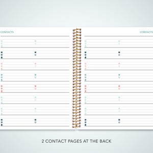 May include: A white planner with a gold spiral binding. The planner has a contact page for each month of the year, with colored tabs for each month. The planner also has two contact pages at the back.