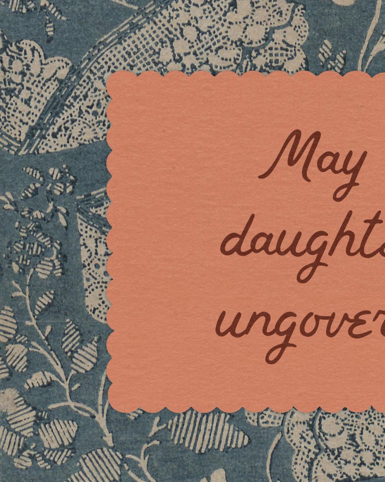 May include: A peach-colored card with scalloped edges, featuring handwritten brown text. The card is set against a backdrop of blue and white floral patterned paper. The text on the card reads "May daughters uncover".