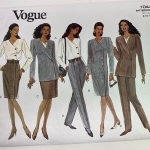 May include: A sewing pattern for a women's suit, featuring four different styles. The pattern is from Vogue and is for sizes 8-10-12. The pattern includes a skirt, pants, and a blazer.
