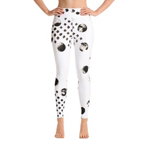 May include: White yoga leggings with a black and white geometric pattern. The pattern features circles, squares, and diamonds.