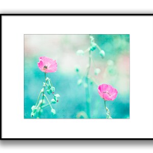 May include: Two pink poppy flowers with green stems and buds against a soft blue and green background.