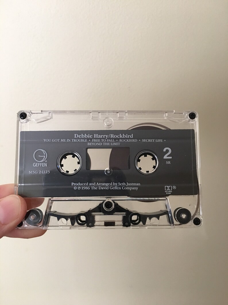 May include: A black cassette tape with a clear plastic case. The tape is labeled "Debbie Harry/Rockbird" and features the songs "You Got Me In Trouble", "Free To Fall", "Rockbird", "Secret Life", and "Beyond The Limit". The tape is a Geffen Records release with the catalog number M5G 24123.