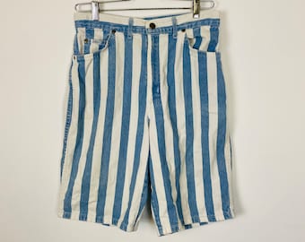 May include: Blue and white striped denim shorts hanging on a silver hanger against a white background.
