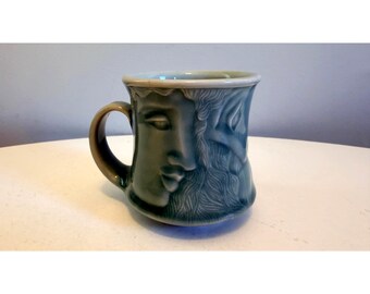 Vintage Scargo Pottery Ceramic Mug Embossed Faces Design Celadon Glaze Signed