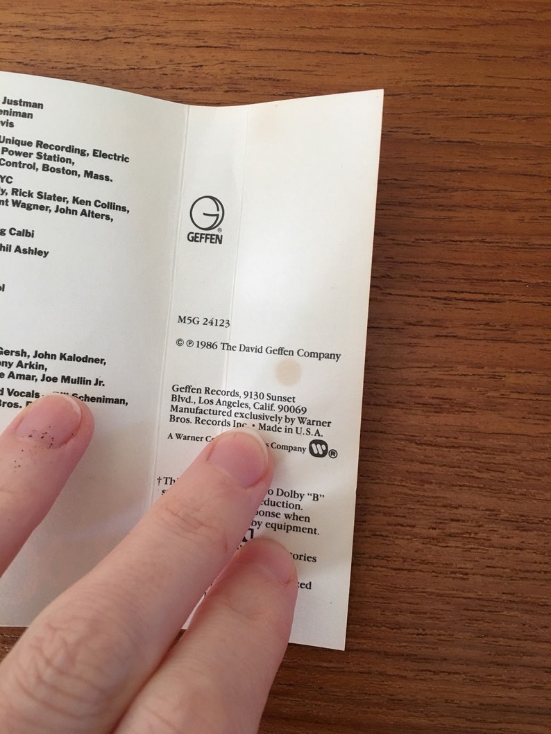 May include: A white cassette tape case with black text. The case features the Geffen Records logo and the text "M5G 24123" and "&copy; 1986 The David Geffen Company".