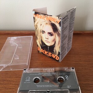 May include: A cassette tape with a clear plastic case. The tape is labeled "Debbie Harry/Rockbird" and features the song titles "You Got Me In Trouble", "Free To Fall", "Rockbird", "Secret Life", and "Beyond The Limit". The tape is a Geffen Records release with the catalog number MSG 24123. The tape is produced and arranged by Seth Justman and is copyrighted 1986 by The David Geffen Company.