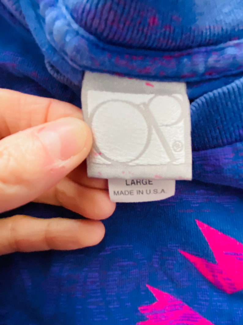 May include: A blue and pink tie-dye t-shirt with a white tag that says "Large" and "Made in U.S.A."