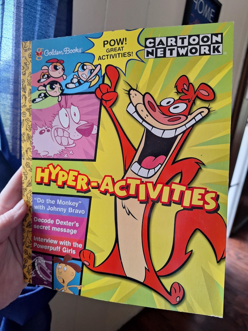 May include: A children's activity book featuring characters from Cartoon Network. The cover has a yellow background with the words "HYPER-ACTIVITIES" and "CARTOON NETWORK." The book includes activities with Johnny Bravo, Dexter, and the Powerpuff Girls.
